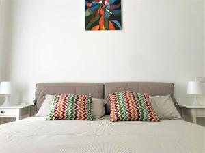 a bed with two pillows on top of it at Eternal City Apartment in Rome