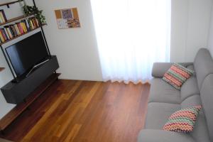 a living room with a couch and a flat screen tv at Eternal City Apartment in Rome