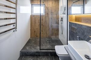 a bathroom with a shower and a toilet and a sink at New designer apartments in Lviv