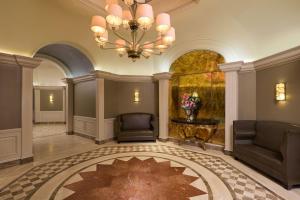 a lobby with a chandelier and a rug at The St. Regis Houston in Houston