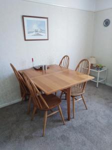 a wooden table with chairs around it in a room at Weather Helm, 18 Highlands Road ,Andover in Andover