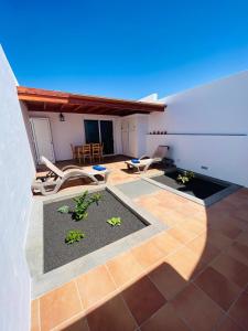 a room with a patio with chairs and a table at Vivienda Vacacional Naia in La Asomada