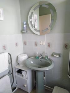 a bathroom with a sink and a mirror at Weather Helm, 18 Highlands Road ,Andover in Andover
