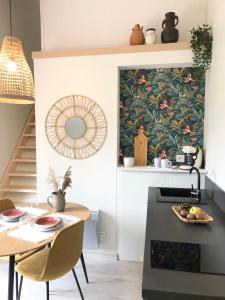 a kitchen with a table and a dining room at Gîte Loufiosa Vannes in Vannes