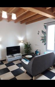 a living room with a couch and a tv at 192 rue de l’Impératrice in Berck-sur-Mer