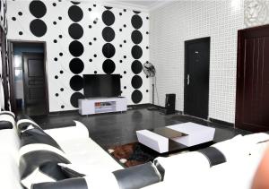 a living room with black and white polka dots on the wall at The Agore Hotels and Suites Ltd in Awoyaya
