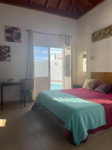 a bedroom with a bed and a view of the ocean at El Limonero in Tías