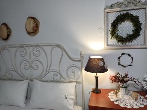 a bedroom with a bed and a table with a lamp at Casa Martina 2 (Spata) 10min El.Venizelos airport. in Spata