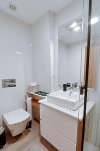 a bathroom with a white sink and a toilet at Sweet living Porto in Valbom