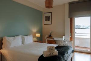 a bedroom with a bed with two pillows on it at Sweet living Porto in Valbom