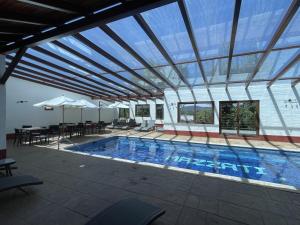 a large swimming pool with a large glass ceiling at cabañas Mazzatl jacuzzy in Mazamitla