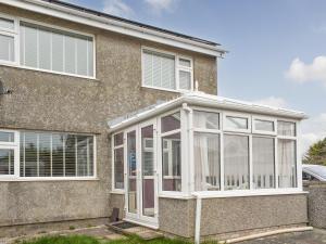 a conservatory on the side of a house at Breuddwydion Cymru welsh Dreams in Cemaes Bay