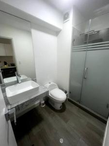a bathroom with a sink and a toilet and a mirror at Moderno mini departamento de estreno in Lima