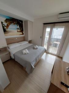 a bedroom with two beds and a large window at Apartmani Tropical in Vodice +74 photos