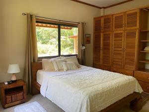 a bedroom with a large bed and a window at Caldera River Canyon in Caldera +29 photos