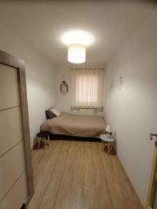Кровать или кровати в номере Apartament Juliusz