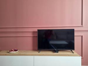 a flat screen tv sitting on top of a table at Comfort Lux Residence in Banja Luka +48 photos
