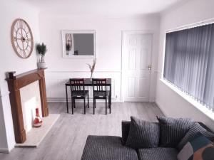a living room with a couch and a table at Exquisite Two Bed Apartment in Grays - Free Wi-Fi and Netflix in Stifford