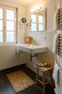bagno con lavandino e specchio di Adler Schiltach Boutique Hotel und Restaurant a Schiltach