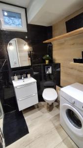 a bathroom with a white toilet and a sink at Studio de charme climatisé Gare Riquier in Nice