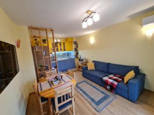 un soggiorno con un divano blu e un tavolo di Riverpark Holiday Apartment, Sandanski a Sandanski