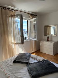 a bedroom with a bed and a large window at Apartment Ivanka in Senj