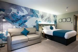 a bedroom with a bed and a couch at The Melville Inn by Innkeeper's Collection in Dalkeith