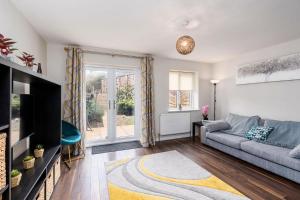 a living room with a couch and a tv at Stunning 3 Bedroom Home Hillsborough Sheffield in Sheffield