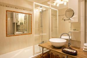 a bathroom with a sink and a shower and a tub at BHG Apartments Prague in Prague