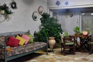 a living room with a couch and a table at Ancient Corinth Guest House in Korinthos