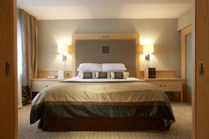 a bedroom with a large bed with two pillows at Lancaster House Hotel in Lancaster