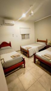 a room with three beds in a room at Lo de Jorge SIN Pileta fuera de temporada in Santiago del Estero