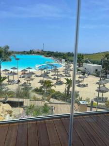 widok na basen z krzesłami i plażę w obiekcie Alcazaba Blue Lagoon 3 bedroom, Ground floor Apartment w mieście Estepona