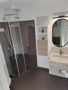 a bathroom with a shower and a sink and a mirror at Modern and comfortable apartment in attractive neighborhood in Stavanger