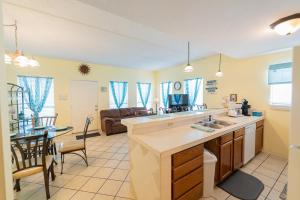 a kitchen and living room with a sink and a table at South Padre Island condo is walking distance to the beach, Sleeps 6, Third Floor, 2024 Traveler Award in South Padre Island