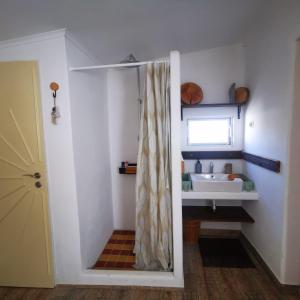 a bathroom with a shower curtain and a sink at Perníková chalúpka in Bojnice