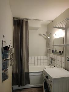 een badkamer met een wastafel en een wasmachine bij Sweet family apartments Hamina in Hamina