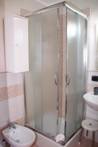 a bathroom with a shower and a toilet and a sink at La Finestra sulla Valle in Agrigento