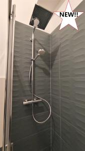 a shower with a shower head in a bathroom at 616 Genova - Loft al Porto Antico in Genoa