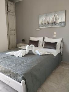 a bedroom with a large bed with sails on the wall at ALKMENE STUDIOS in Skiathos