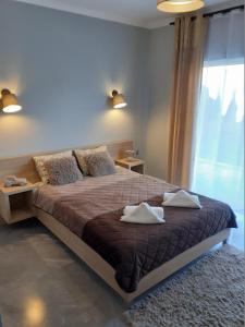 a bedroom with a large bed with pillows and a window at Villa EDEN USTKA in Ustka