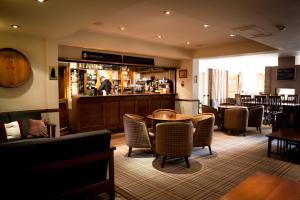 a restaurant with a bar and tables and chairs at Lancaster House Hotel in Lancaster
