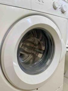 a white washing machine with its door open at Modern fully equipped two story appartement/duplex in Safi