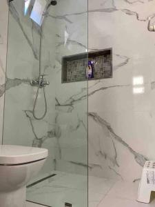 a bathroom with a shower and a toilet at Modern fully equipped two story appartement/duplex in Safi