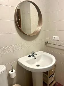 a bathroom with a sink and a mirror at Ayamonte - Vista Esuri Golf and Beach in Huelva
