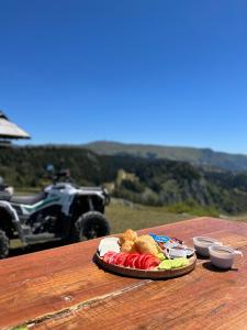 a plate of food sitting on a table with a atv at Pansion A&M Vlašić in Vlasic