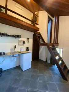 a kitchen with a loft with a counter and a sink at Villa Rustica Praia dos Anjos in Arraial do Cabo