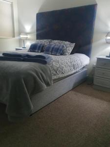 a bedroom with a bed with two pillows on it at Junior Suite Town Centre in Dungarvan