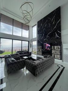 a large living room with couches and a tv at Luxury Triplex Villa in Trabzon