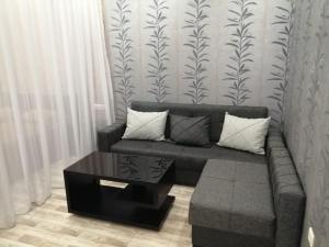 a living room with a couch and a coffee table at Comfort Lux in Tbilisi City